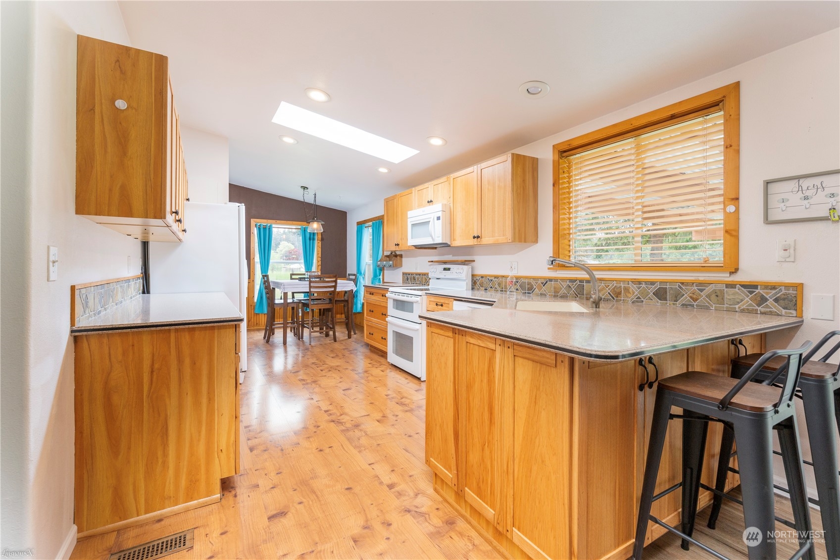 9138 176th Avenue Southwest Rochester, WA 98579 - Photo 11 of 25 a kitchen with a table chairs sink and cabinets