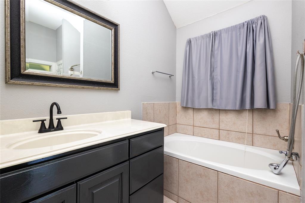 512 Milton Road Josephine, TX 75173 - Photo 13 of 31 a bathroom with a sink and a mirror