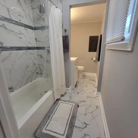 a view of a glass door with a bench in front of it