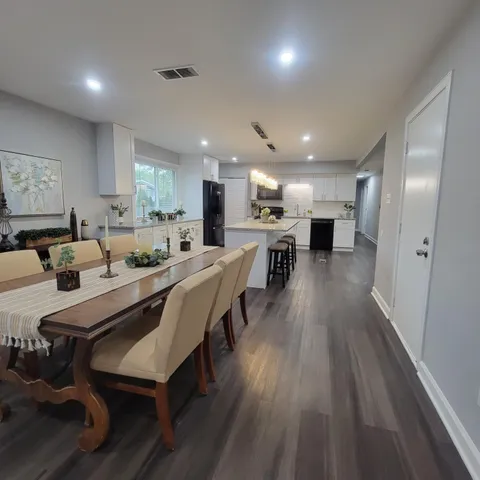 a large kitchen with a table and chairs
