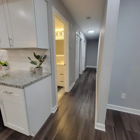 a view of hallway with wooden floor