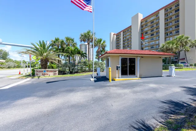 a view of a building with a yard and plants
