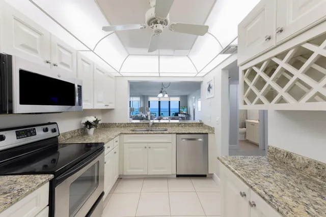 a kitchen with stainless steel appliances granite countertop a sink and a stove