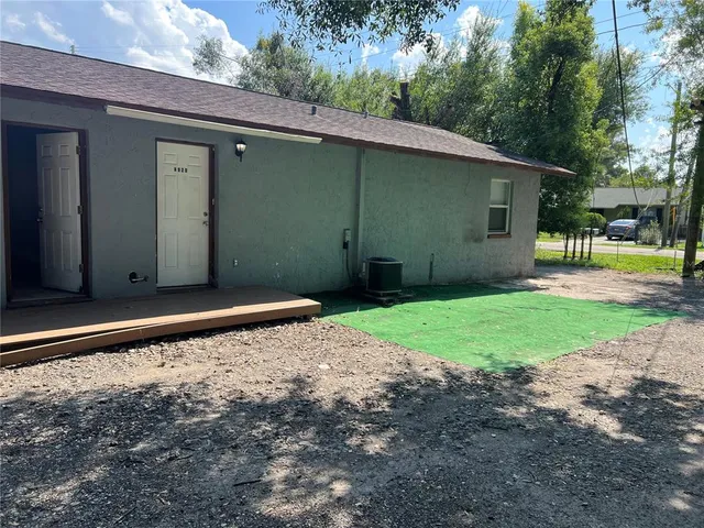 a backyard of a house with barbeque oven