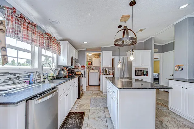 a bathroom with a granite countertop sink a mirror and a toilet