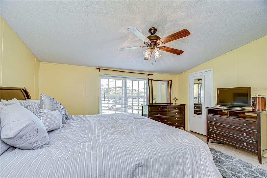 43650 County Road 54 East Kathleen, FL 33849 - Photo 23 of 72 a bedroom with a bed and a flat screen tv