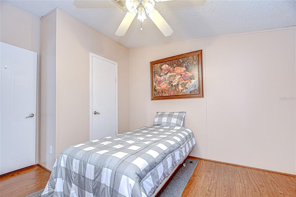 43650 County Road 54 East Kathleen, FL 33849 - Photo 29 of 72 a bedroom with a bed and a painting on the wall
