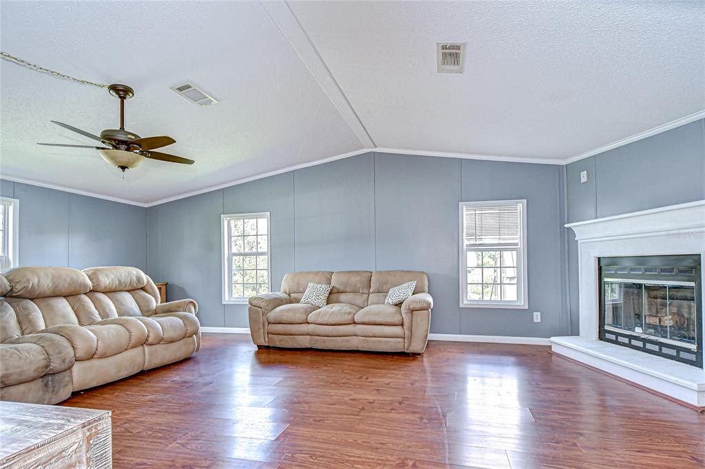 43650 County Road 54 East Kathleen, FL 33849 - Photo 33 of 72 a living room with furniture and a fireplace
