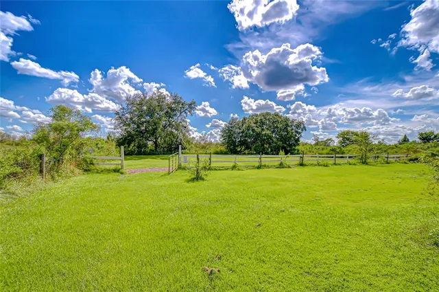 an aerial view of a house with a garden and yard