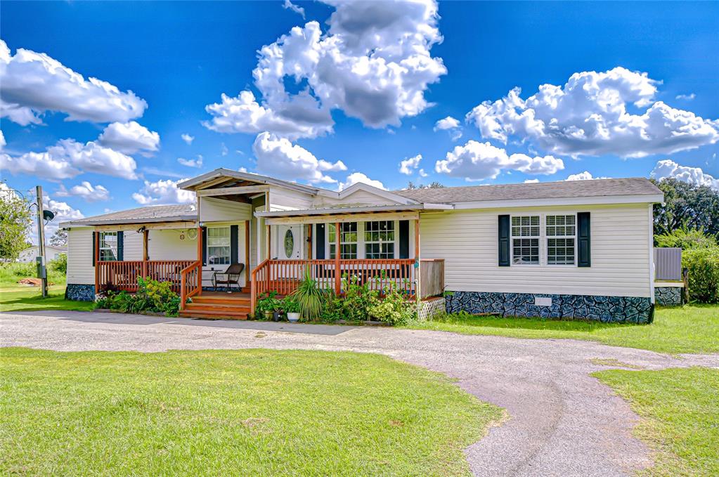 43650 County Road 54 East Kathleen, FL 33849 - Photo 68 of 72 a front view of a house with a porch and a yard