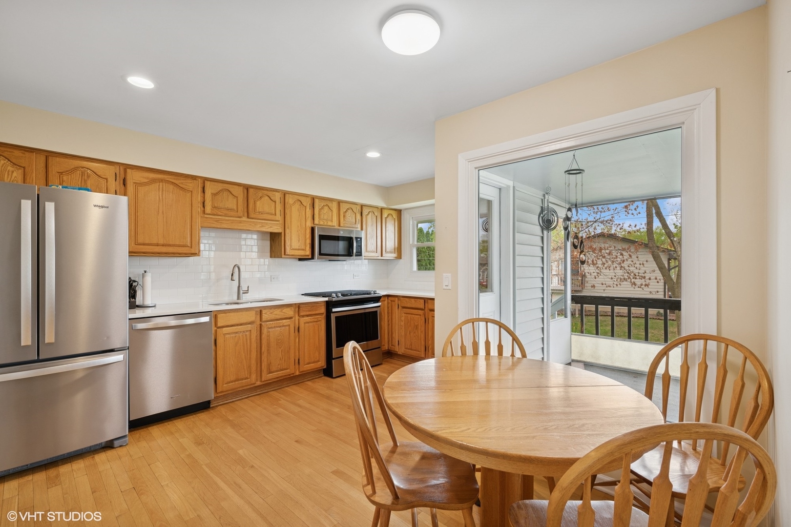 1750 Chippendale Road Hoffman Estates, IL 60169 - Photo 5 of 19 a kitchen with stainless steel appliances granite countertop a stove a refrigerator a kitchen island a table and chairs