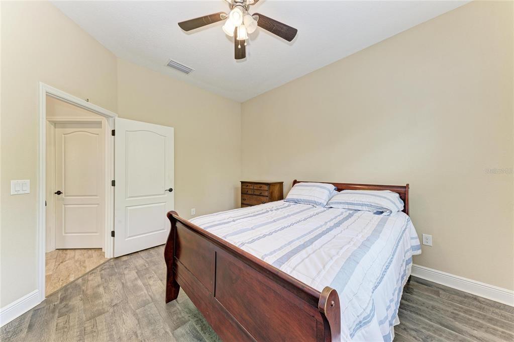 12642 Harney Street Venice, FL 34293 - Photo 36 of 85 a bedroom with a bed and a chandelier