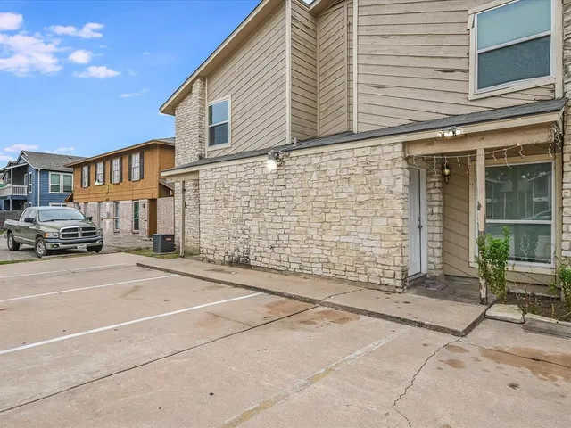 a view of a brick house with many windows
