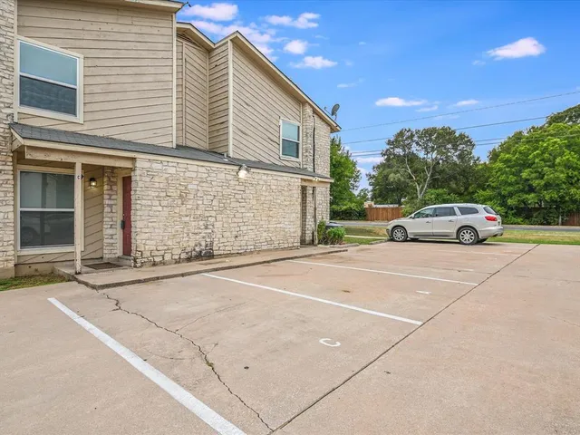 a view of a car parked in front of a building