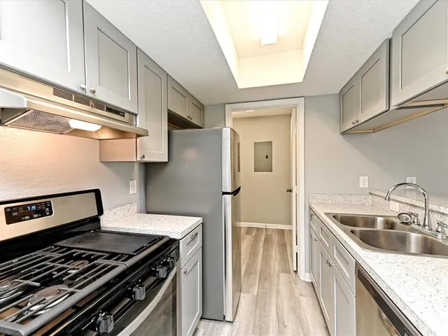 a kitchen with a stove and a sink