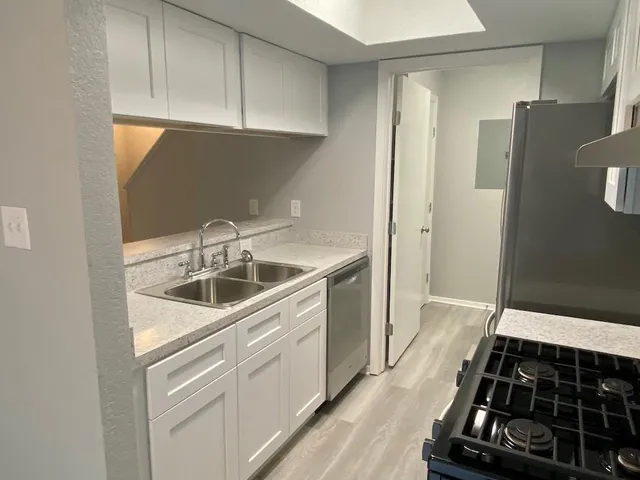 a kitchen with a refrigerator and a sink