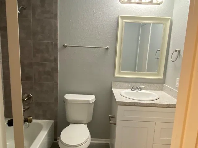 a bathroom with a toilet sink and shower
