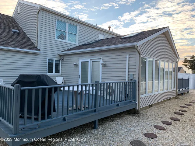 a view of a house with wooden fence