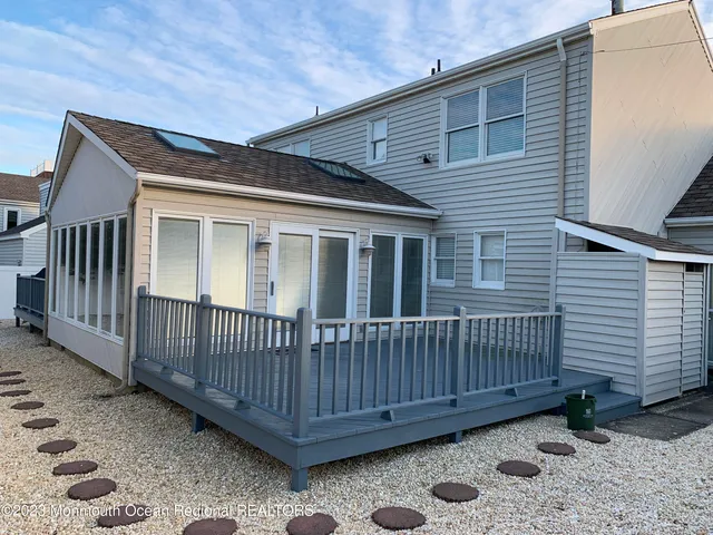 a view of a house with wooden deck