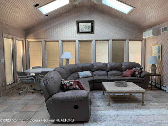 a living room with furniture and large windows