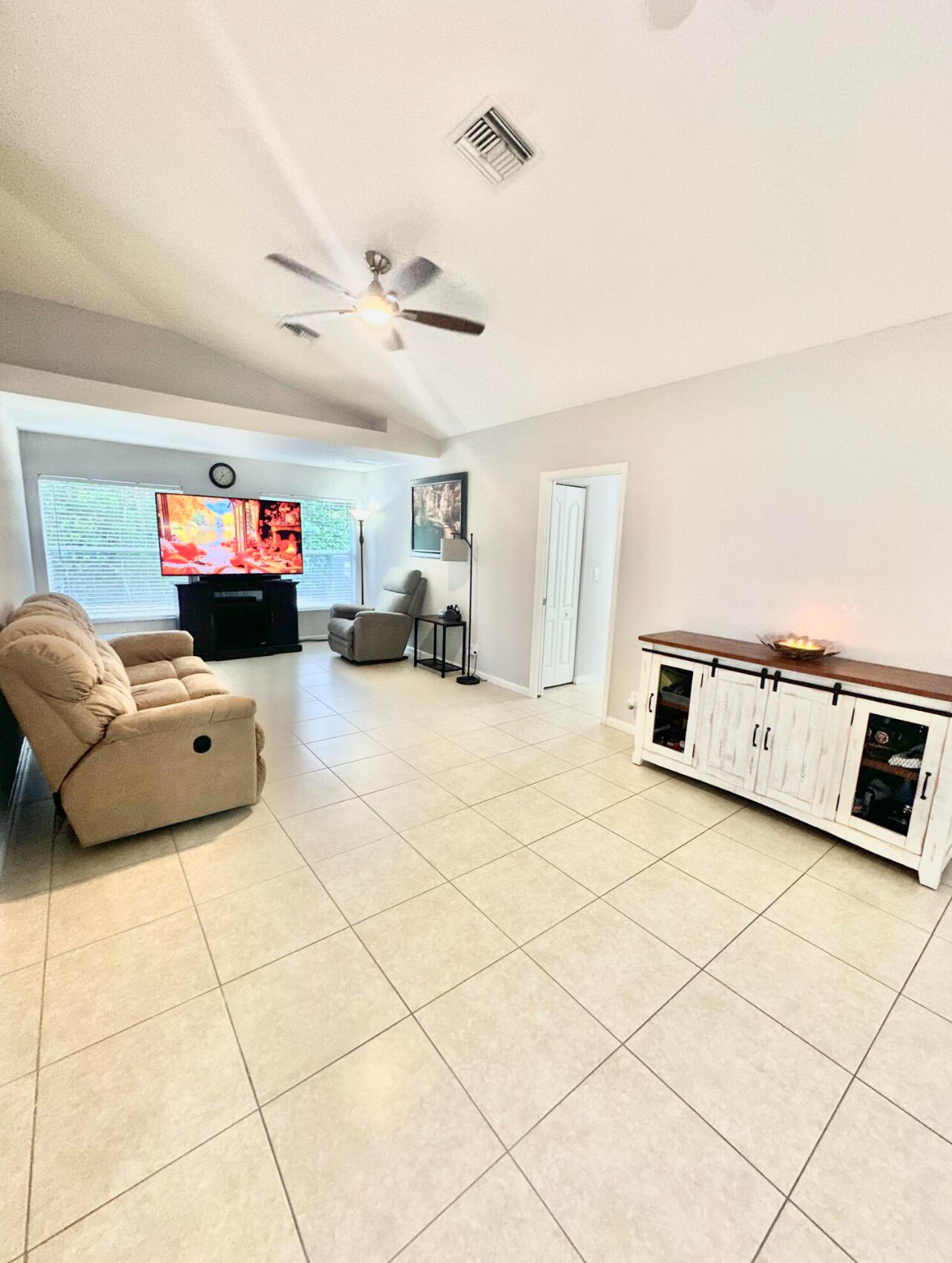 13218 86th Road North The Acreage, FL 33412 - Photo 15 of 69 a living room with furniture and a chandelier