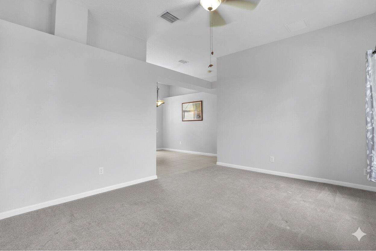 13218 86th Road North The Acreage, FL 33412 - Photo 21 of 69 an empty room with a empty space and a ceiling fan