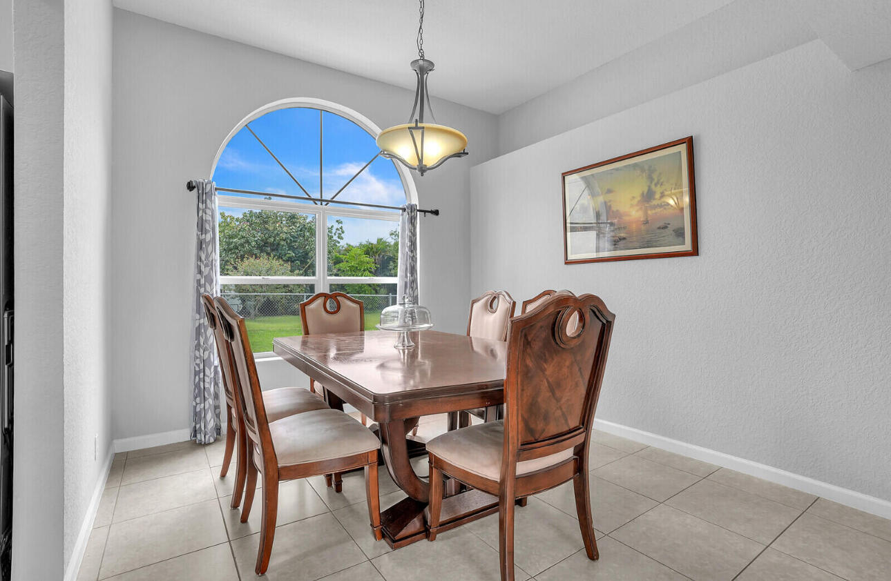 13218 86th Road North The Acreage, FL 33412 - Photo 27 of 69 a view of a dining room with furniture window and outside view
