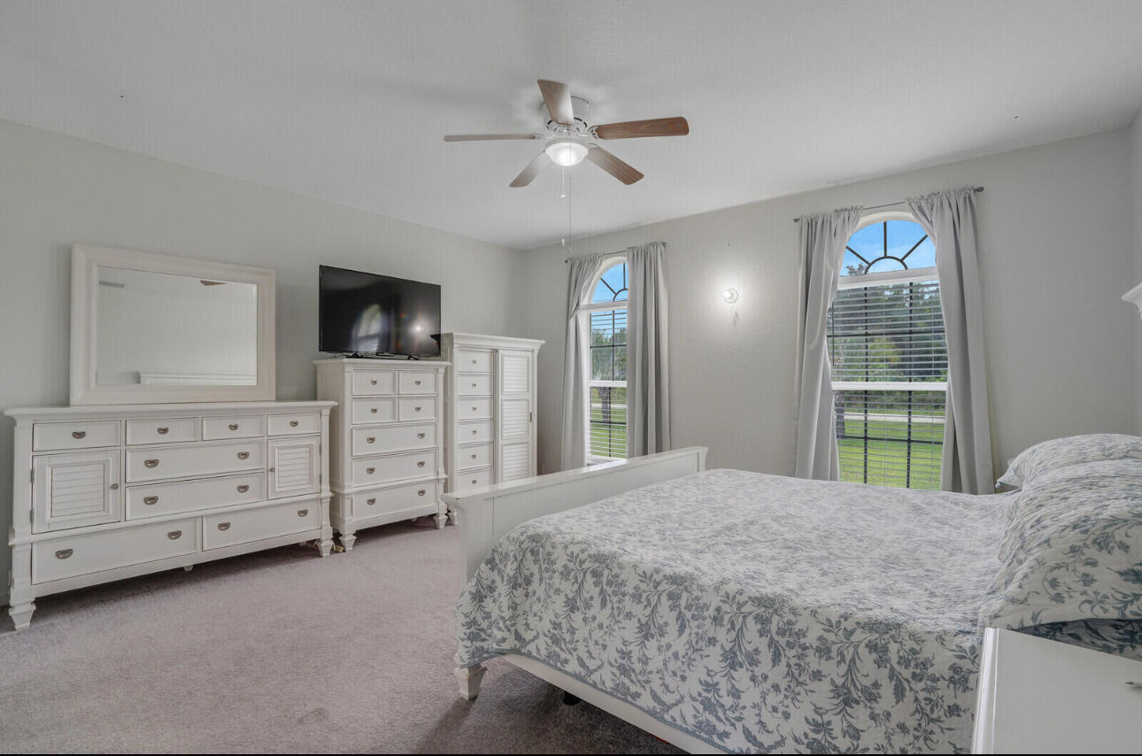 13218 86th Road North The Acreage, FL 33412 - Photo 33 of 69 a bedroom with a bed a window and a television