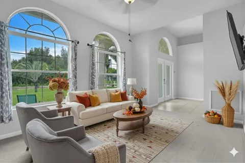 a bedroom with a bed a window and a television