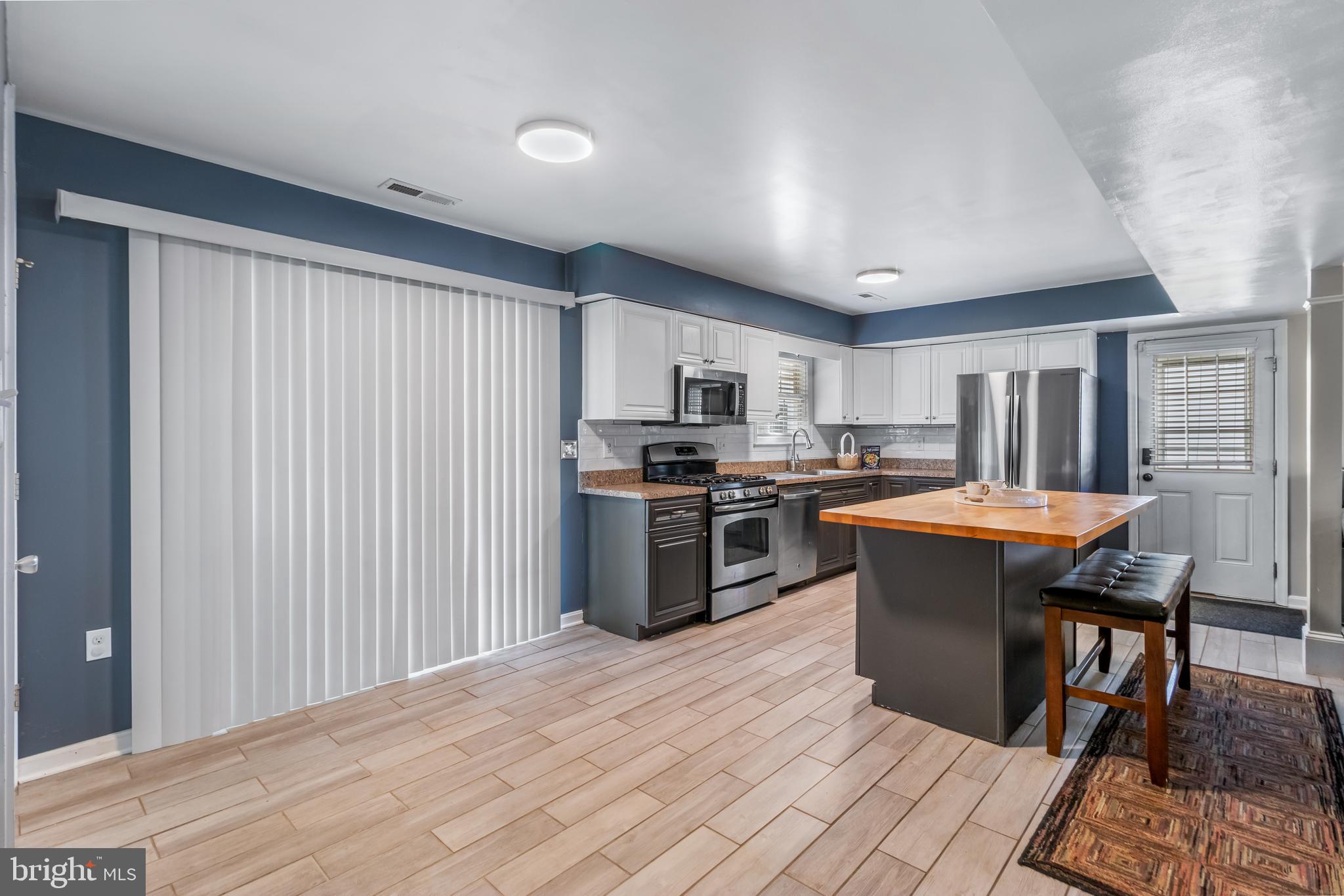22 Marshall Road Waldorf, MD 20602 - Photo 12 of 41 a kitchen with stainless steel appliances granite countertop a stove a sink dishwasher a microwave oven with a dining table and chairs