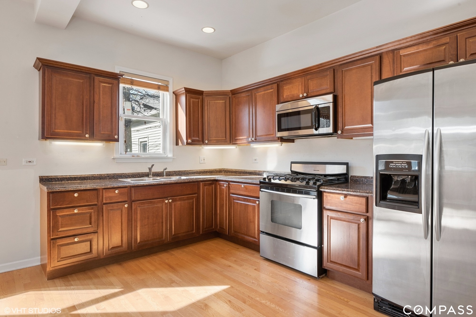 3304 North Hamilton Avenue, Unit R Chicago, IL 60618 - Photo 4 of 18 a kitchen with stainless steel appliances granite countertop a refrigerator microwave and sink