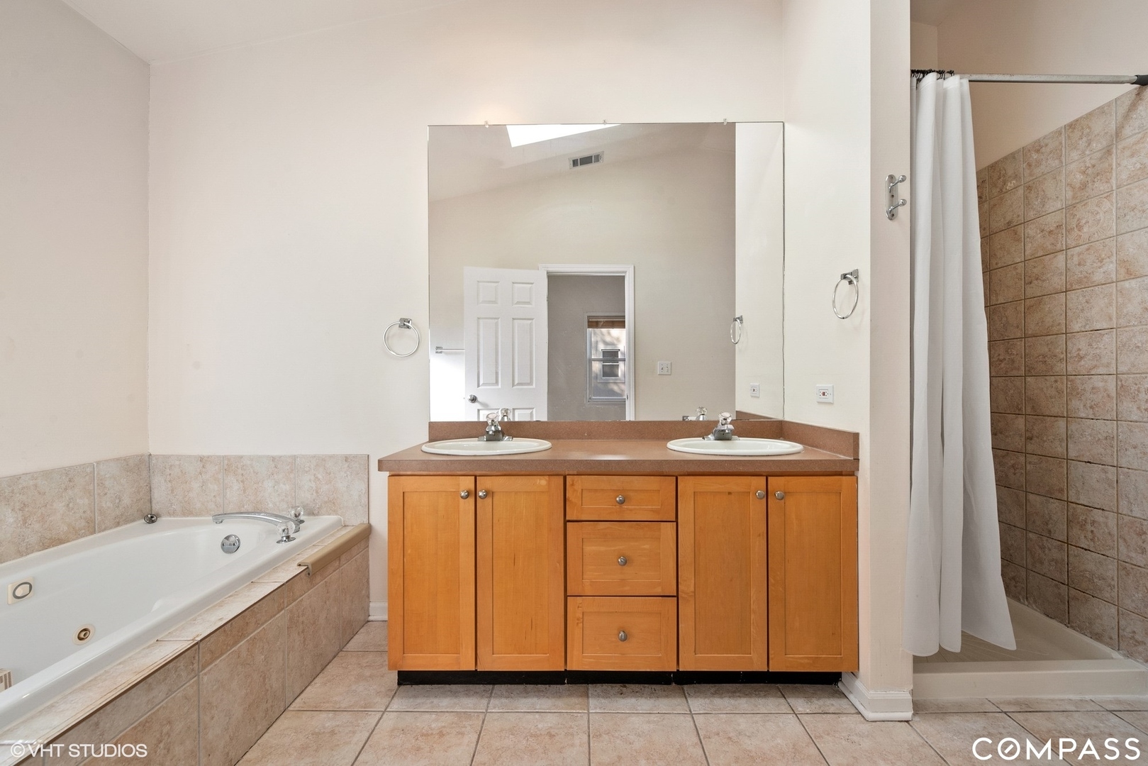 3304 North Hamilton Avenue, Unit R Chicago, IL 60618 - Photo 7 of 18 a bathroom with a granite countertop bathtub a sink and a mirror
