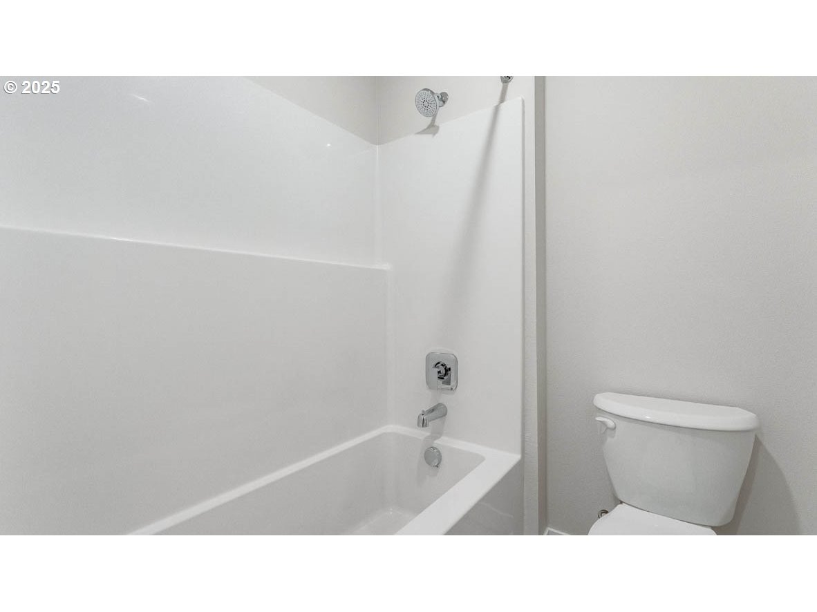9463 Southeast Crystal Rose Street Happy Valley, OR 97086 - Photo 17 of 27 a bathroom with a sink a toilet and bathtub