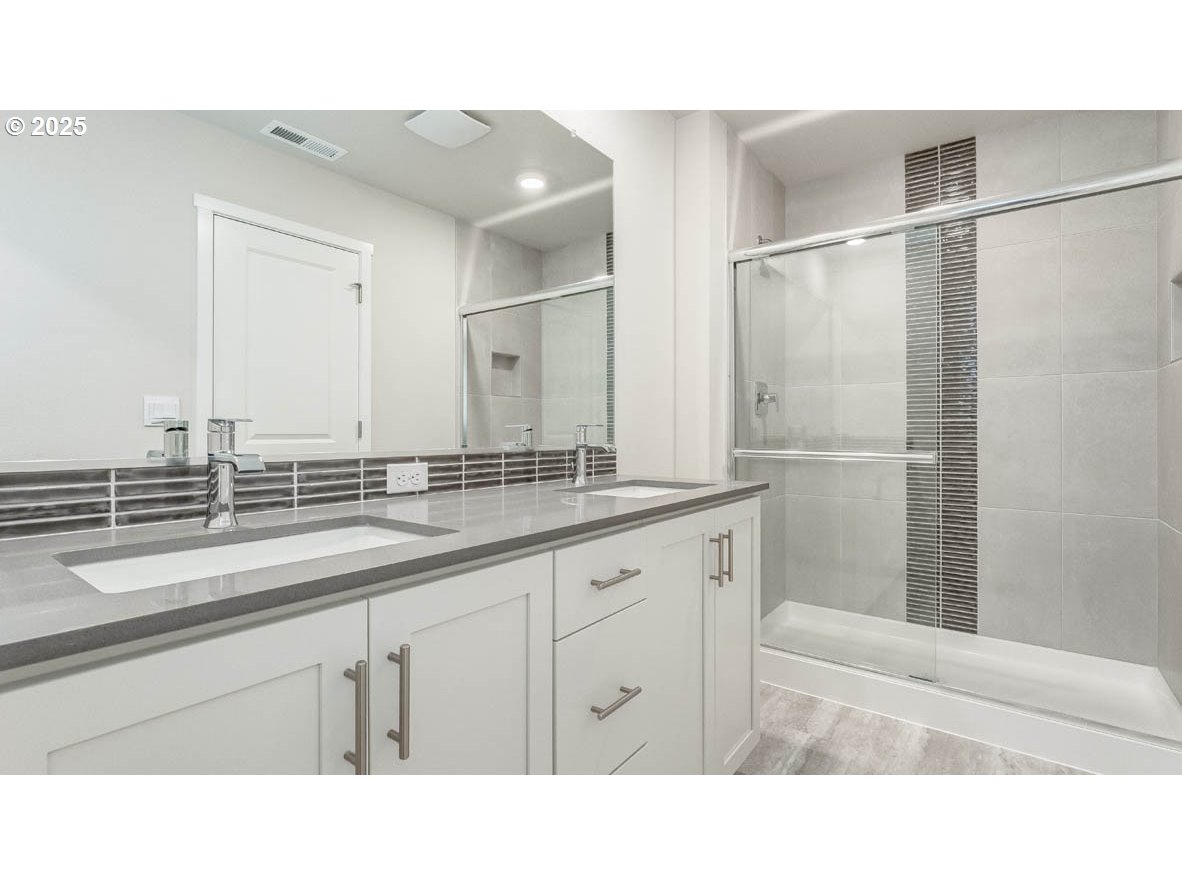 9463 Southeast Crystal Rose Street Happy Valley, OR 97086 - Photo 23 of 27 a bathroom with a sink and a mirror