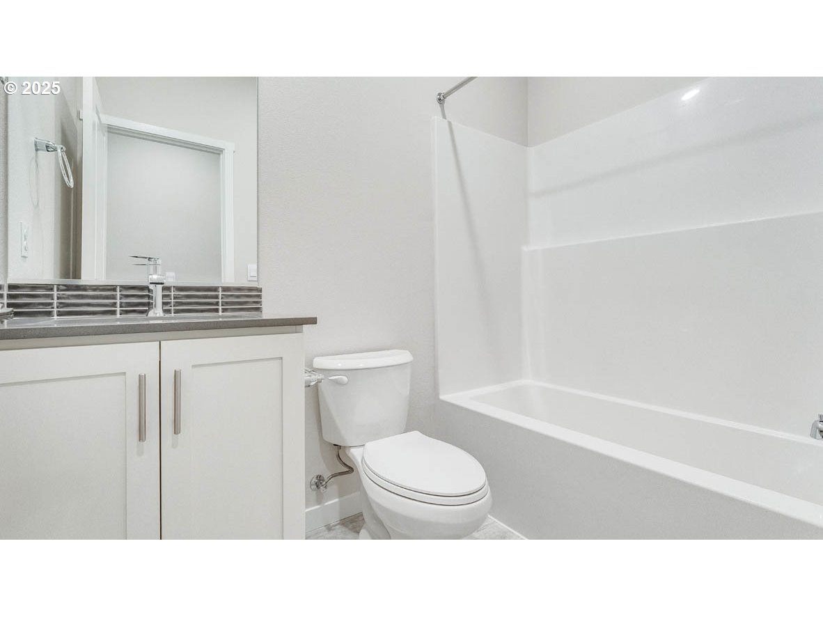 9463 Southeast Crystal Rose Street Happy Valley, OR 97086 - Photo 3 of 27 a bathroom with a sink a toilet and shower