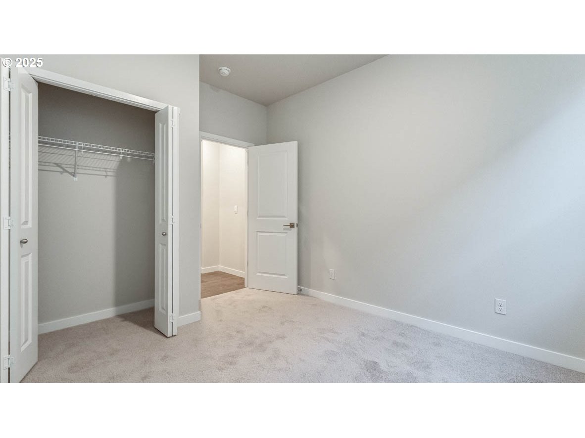 9463 Southeast Crystal Rose Street Happy Valley, OR 97086 - Photo 5 of 27 a open living room with a hallway