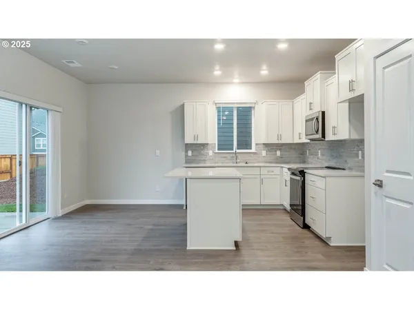 a kitchen with a sink cabinets and window