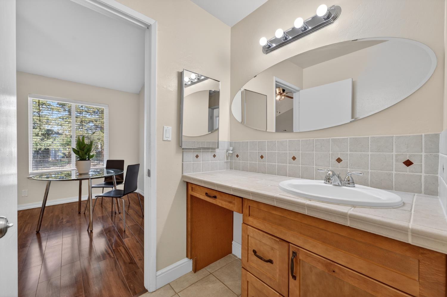 6146 Shadow Lane Citrus Heights, CA 95621 - Photo 21 of 45 a en suite bathroom with double sink and a mirror
