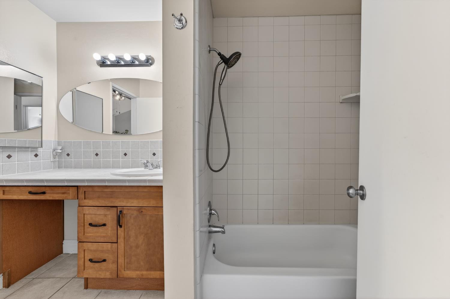 6146 Shadow Lane Citrus Heights, CA 95621 - Photo 22 of 45 a bathroom with a bathtub shower sink vanity and mirror