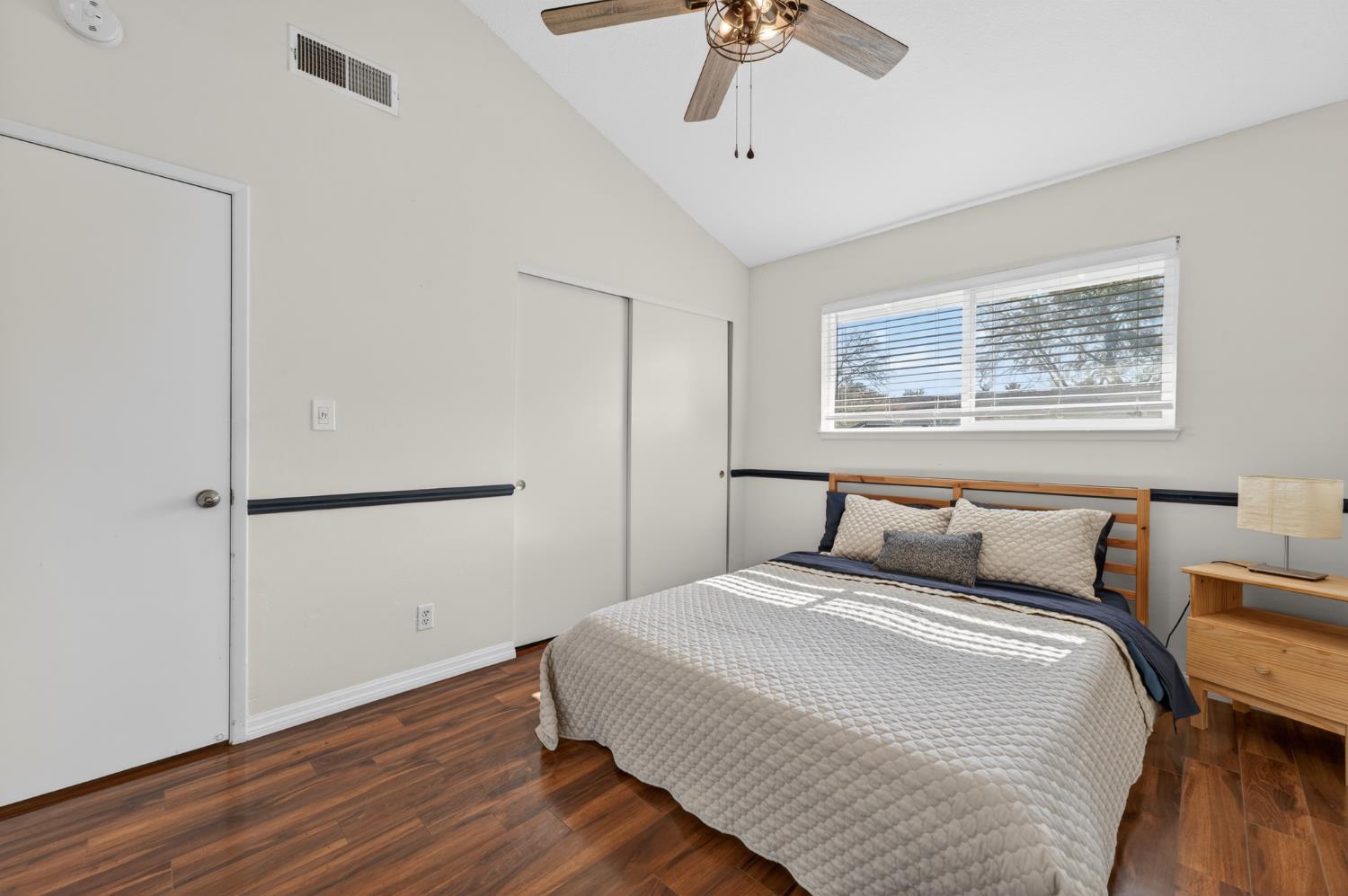 6146 Shadow Lane Citrus Heights, CA 95621 - Photo 24 of 45 a bedroom with a large bed and a chandelier