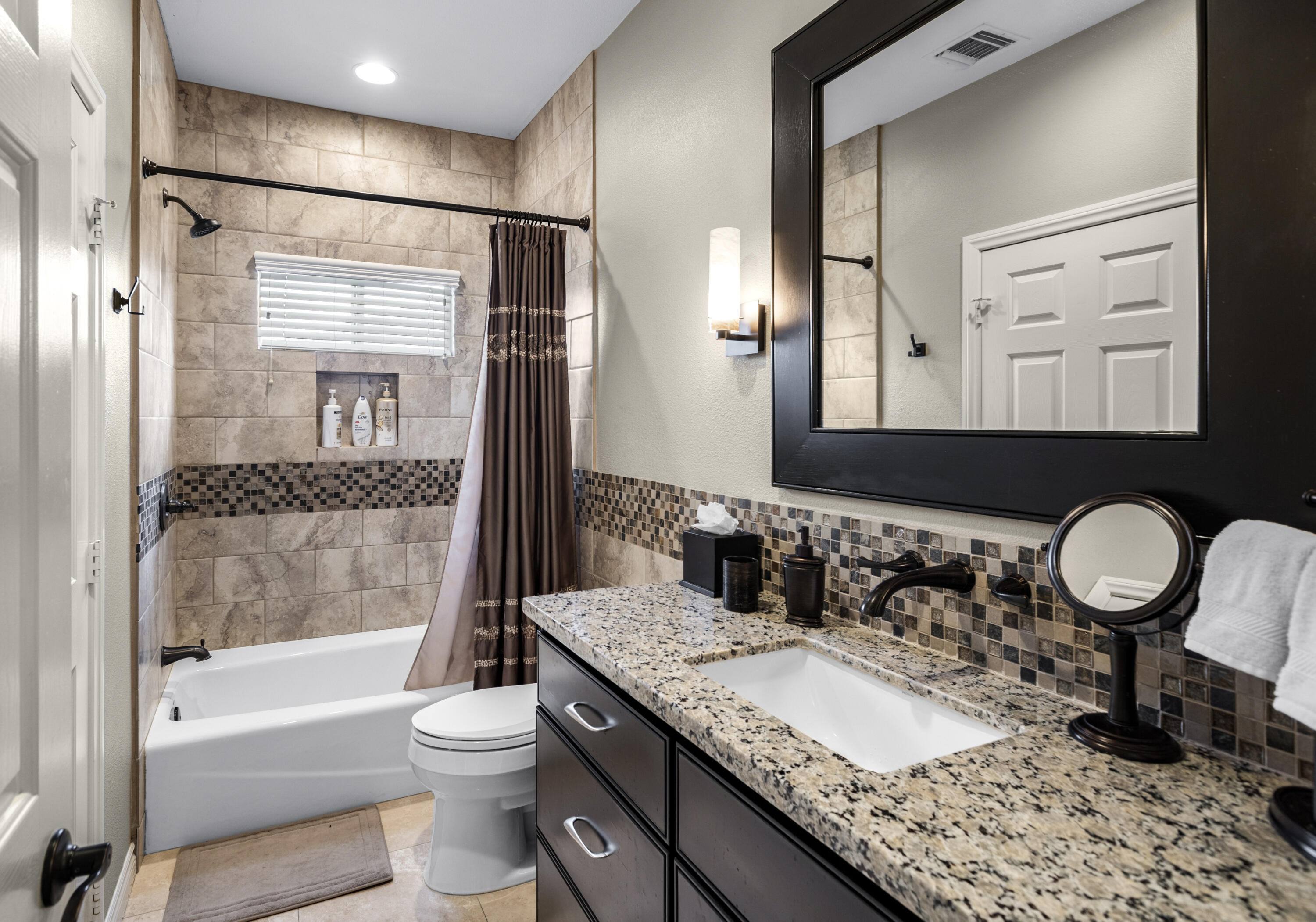 68590 Risueno Road Cathedral City, CA 92234 - Photo 26 of 72 a bathroom with a granite countertop sink toilet mirror and a bathtub