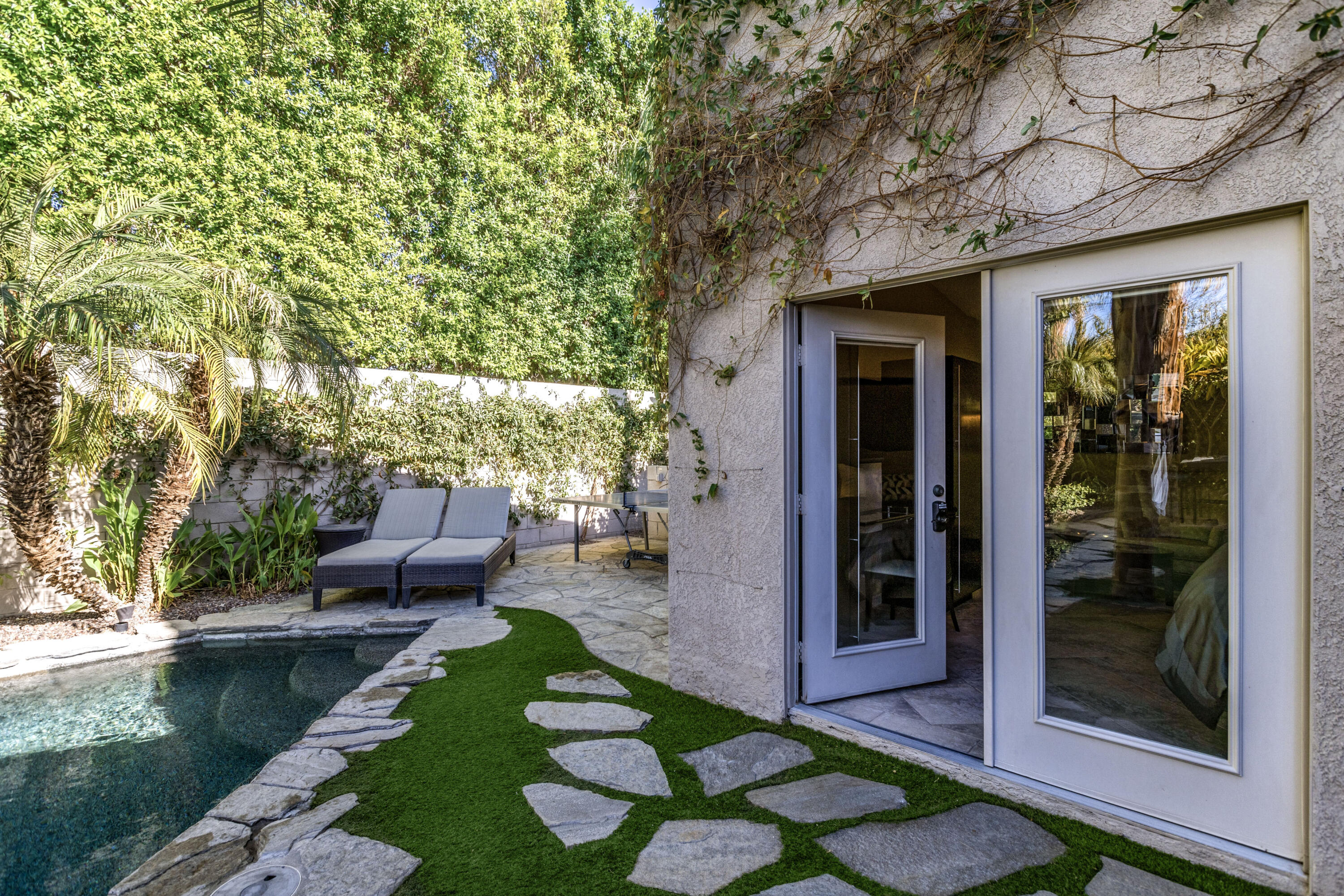 68590 Risueno Road Cathedral City, CA 92234 - Photo 38 of 72 a view of a patio with couches table and chairs and potted plants with sky view