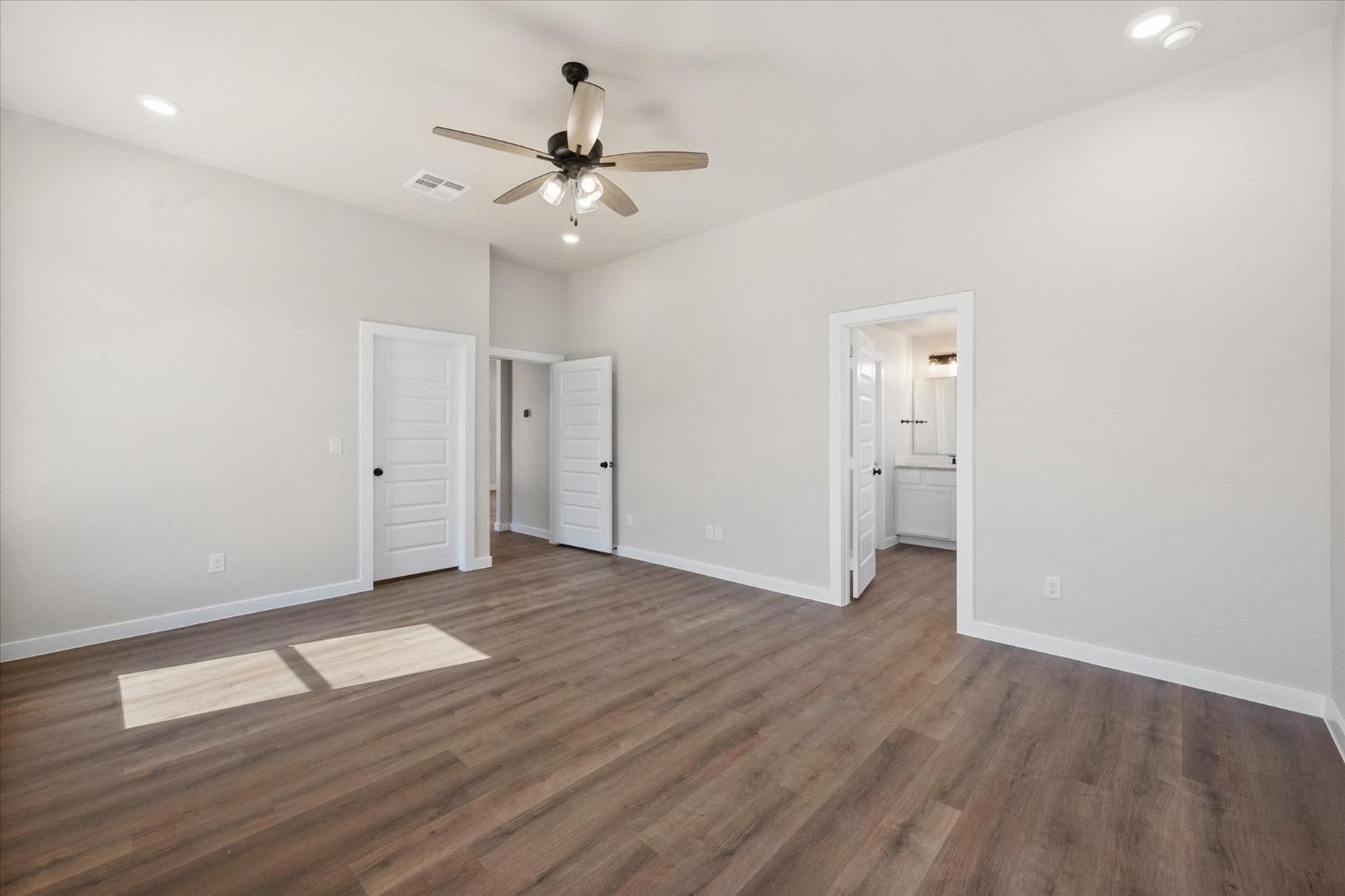 6917 55th Street Lubbock, TX 79407 - Photo 12 of 20 a view of an empty room with wooden floor