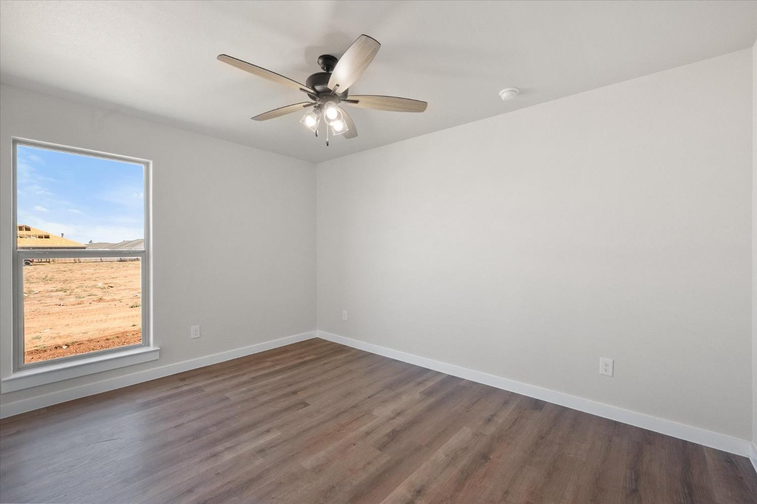 6917 55th Street Lubbock, TX 79407 - Photo 18 of 20 wooden floor in an empty room with a window