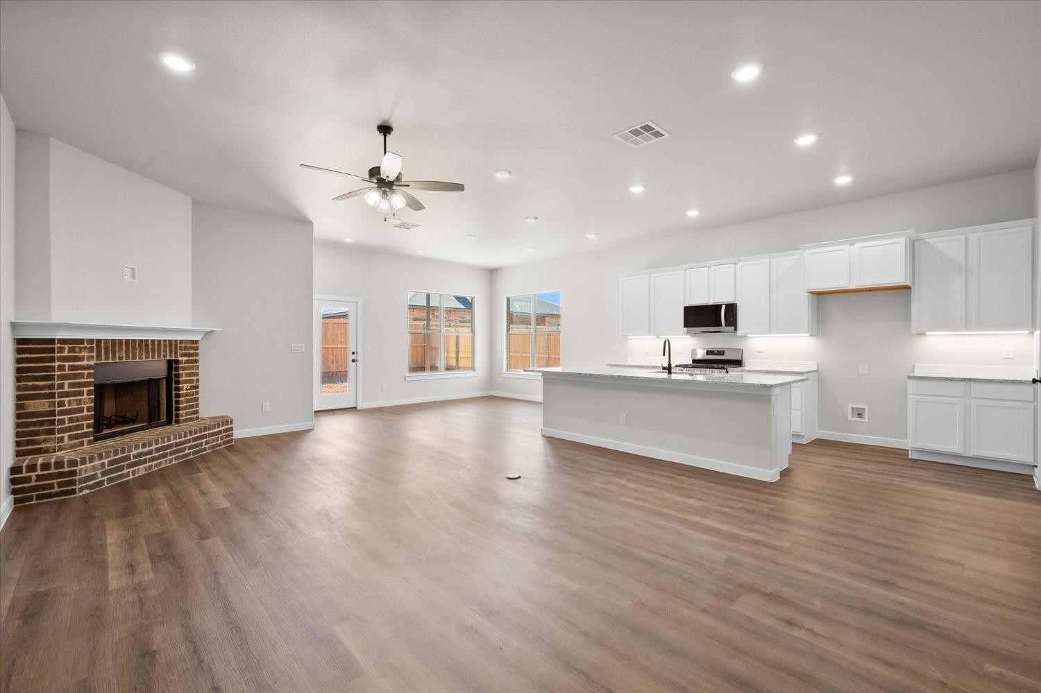 6917 55th Street Lubbock, TX 79407 - Photo 3 of 20 a view of kitchen with sink microwave and refrigerator