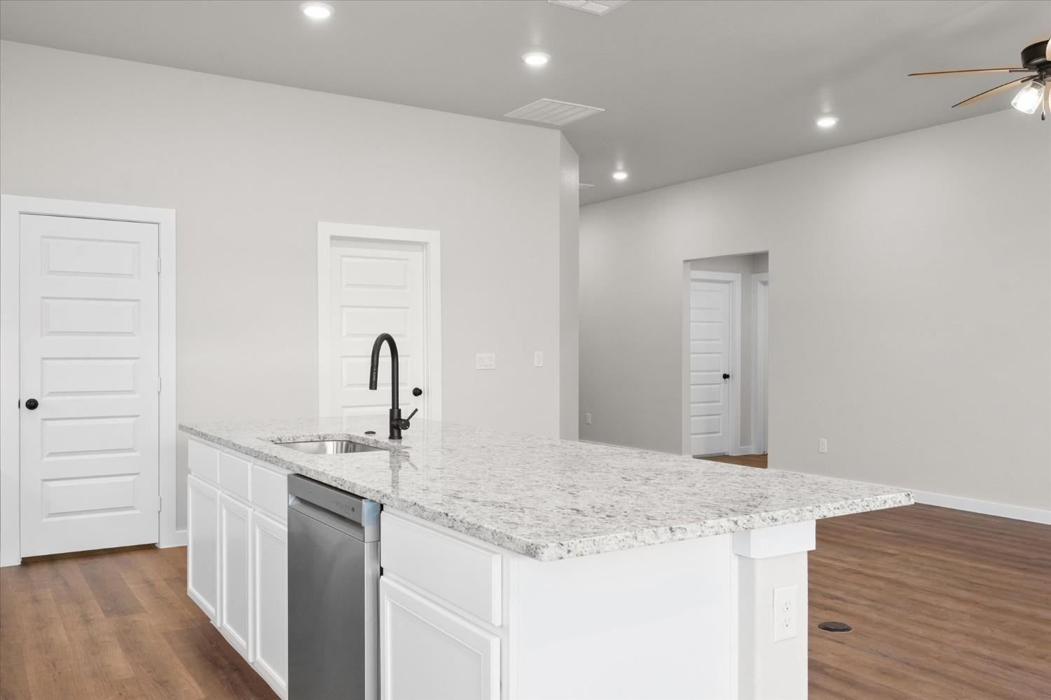 6917 55th Street Lubbock, TX 79407 - Photo 8 of 20 a kitchen with a sink and a refrigerator