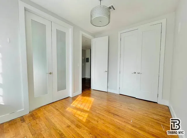 a view of a room with wooden floor and bathroom
