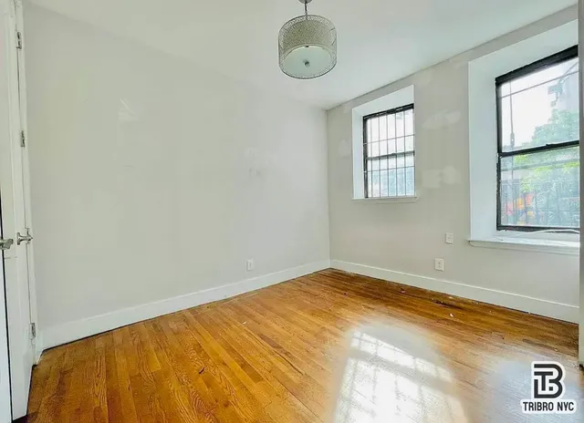a view of a room with window and wooden floor