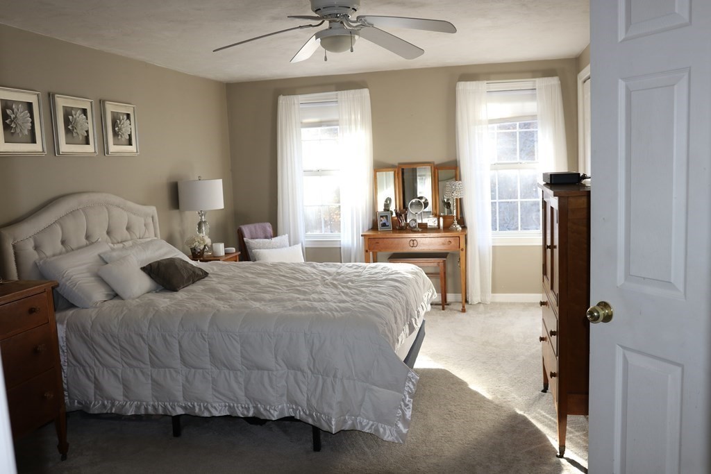28 South Meadow Road Clinton, MA 01510 - Photo 17 of 24 a bedroom with a bed and a chandelier