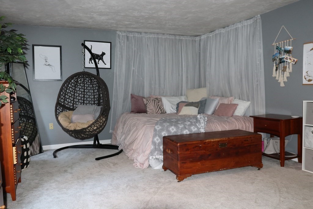 28 South Meadow Road Clinton, MA 01510 - Photo 20 of 24 a bedroom with a bed a table and painting on the wall